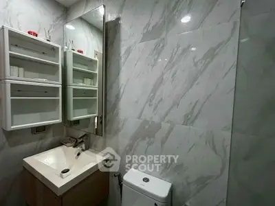 Modern bathroom with sleek marble tiles and stylish vanity unit