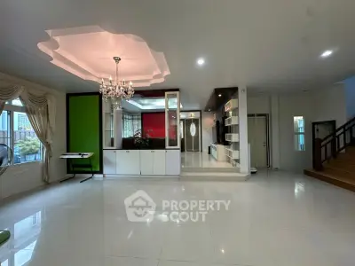 Spacious modern living room with elegant chandelier and stylish decor