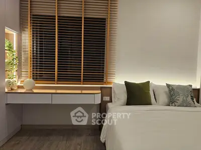 Modern bedroom with stylish blinds and cozy bedding
