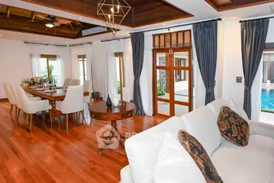 Luxurious open-plan living and dining area with elegant wooden flooring and pool view.