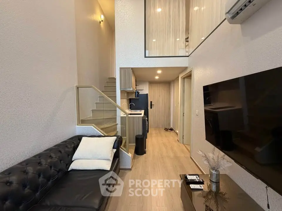 Modern duplex living room with stylish decor and open staircase