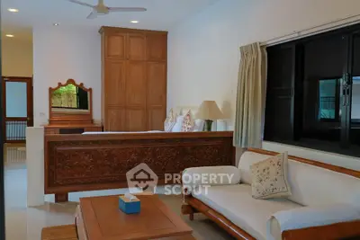 Spacious living room with elegant wooden furniture and large window