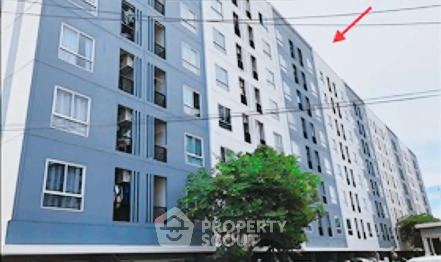 Modern multi-story residential building with sleek facade and large windows.