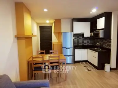 Modern kitchen and dining area with sleek design and wooden accents