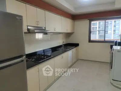 Spacious kitchen with modern appliances and gas stove in a bright apartment