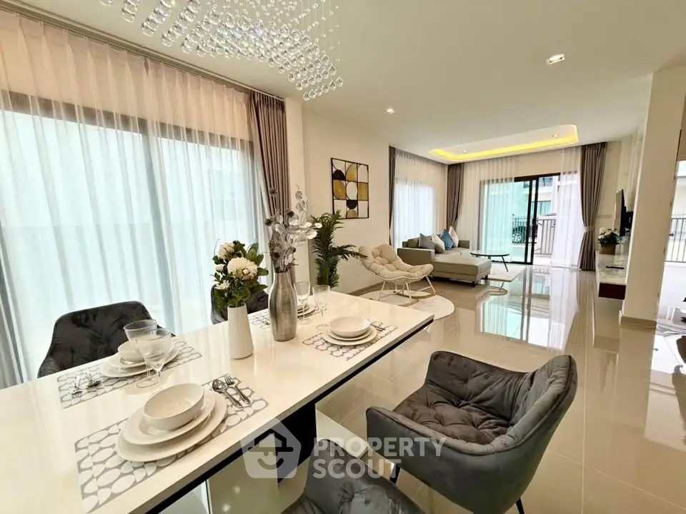 Luxurious open-plan living and dining area with elegant decor and natural light.