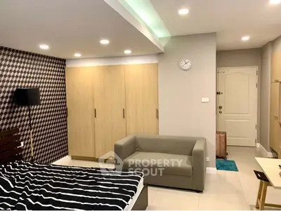 Modern bedroom with stylish decor and cozy seating area