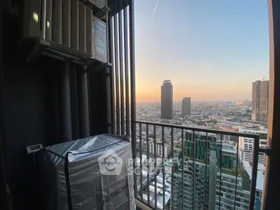 Stunning city view from a high-rise balcony at sunset, perfect for urban living.