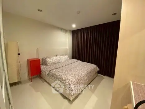 Cozy bedroom with modern decor and ample natural light