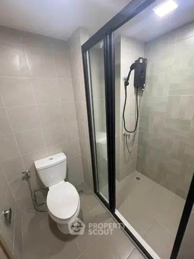 Modern bathroom with sleek shower enclosure and tiled walls