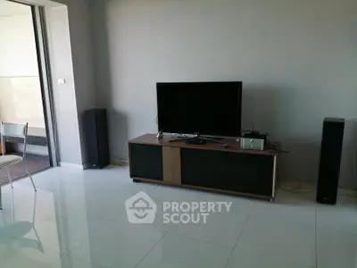 Modern living room with sleek TV setup and balcony view