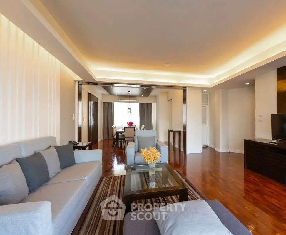 Spacious living room with modern furniture and elegant lighting