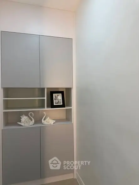 Modern minimalist storage cabinet with decorative swans and framed art