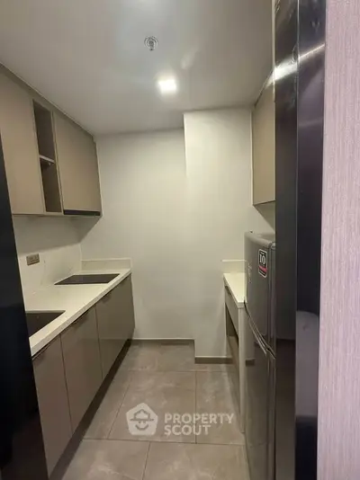 Modern kitchen with sleek cabinetry and built-in appliances in a compact layout.