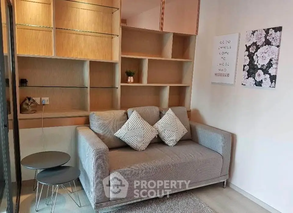 Modern living room with stylish shelving and cozy gray sofa