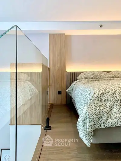 Modern bedroom with glass railing and stylish wooden accents