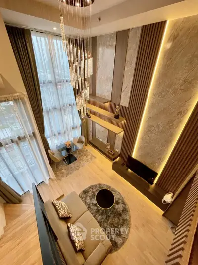 Luxurious high-ceiling living room with modern decor and stunning chandelier
