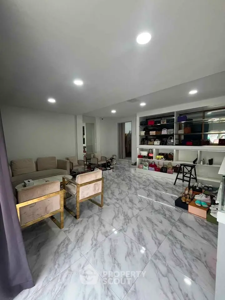 Spacious living room with elegant marble flooring and modern furniture, perfect for stylish urban living.