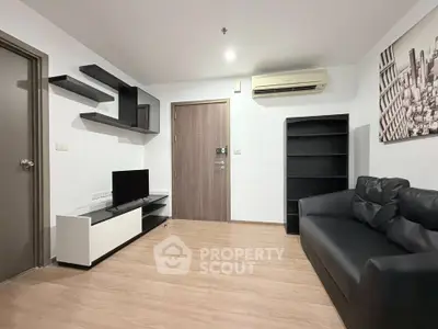 Modern living room with sleek furniture and wall-mounted shelves, featuring a cozy black sofa and flat-screen TV.