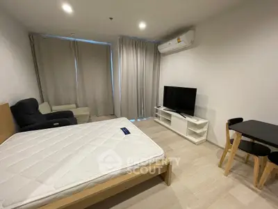 Modern studio apartment with minimalist furniture and natural light