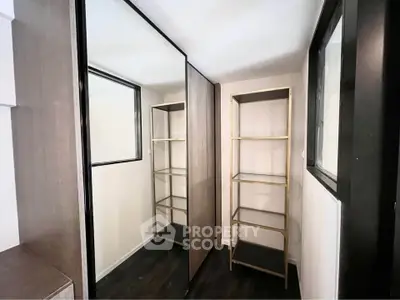 Modern storage room with mirrored sliding doors and sleek shelving
