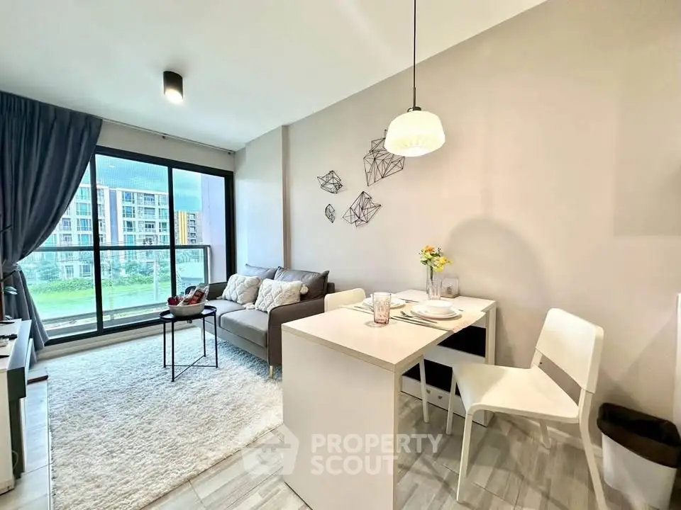 Modern living room with dining area and large window view in stylish apartment