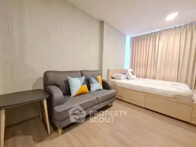 Modern bedroom with stylish sofa and natural light, perfect for relaxation and comfort.