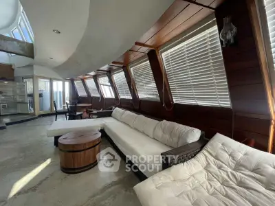 Luxurious curved living room with modern design and ample natural light.