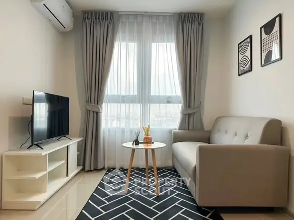 Modern living room with stylish decor, cozy sofa, and large window for natural light.