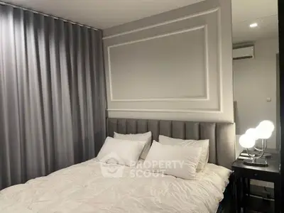 Elegant bedroom with modern decor and plush bedding in a stylish apartment.