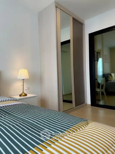 Modern bedroom with stylish decor and mirrored wardrobe