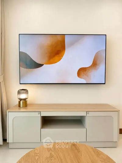 Modern living room with stylish TV setup and elegant wooden furniture