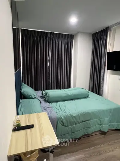 Cozy bedroom with modern decor and natural light, featuring a comfortable bed and stylish curtains.