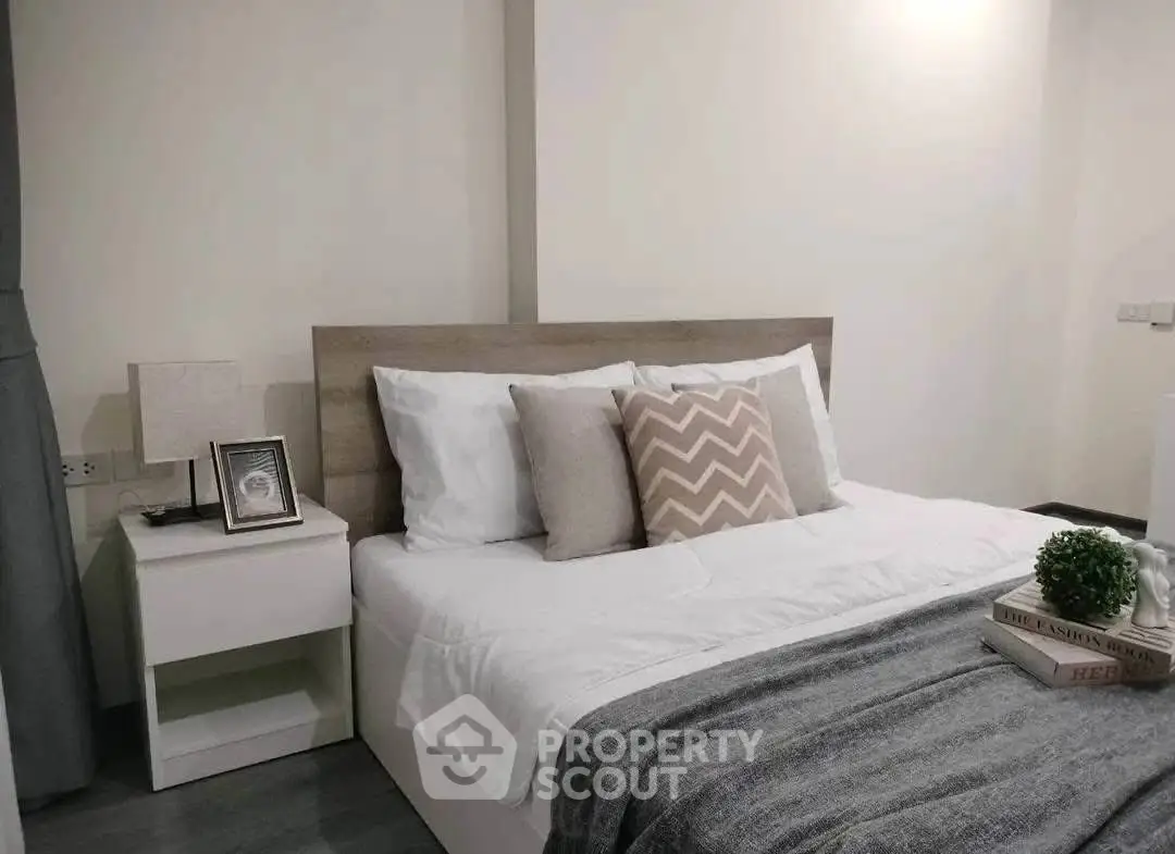 Cozy bedroom with modern decor and stylish bedding in a contemporary apartment.