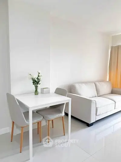 Modern minimalist living room with white sofa and dining table, perfect for cozy urban living.