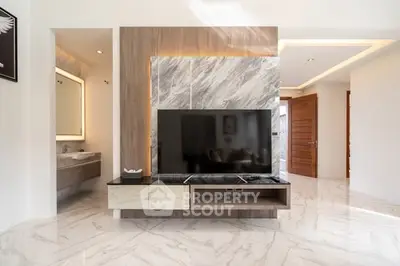 Modern living room with sleek TV unit and marble flooring