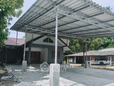 Spacious residential property with large covered carport and modern exterior design.