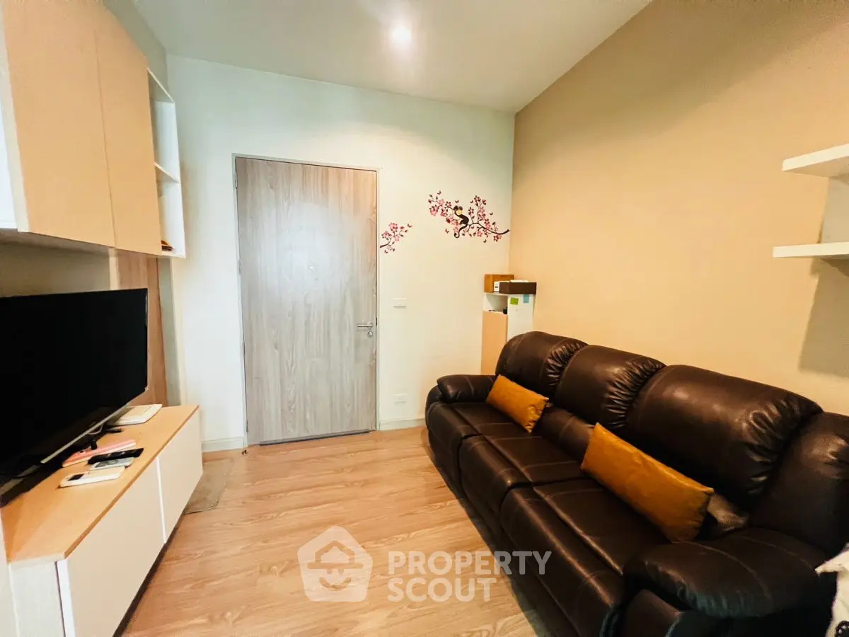 Cozy living room with leather sofa and modern TV setup