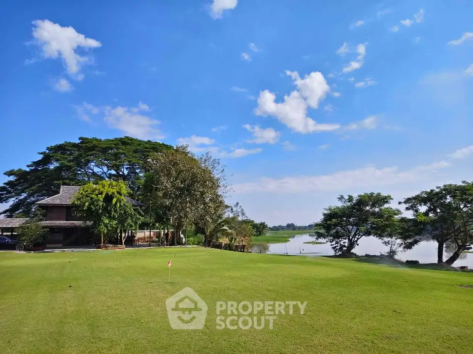 Stunning lakeside view with lush greenery and clear blue skies, perfect for serene living.