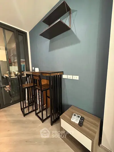 Modern interior with stylish bar stools and shelving in a cozy living space.