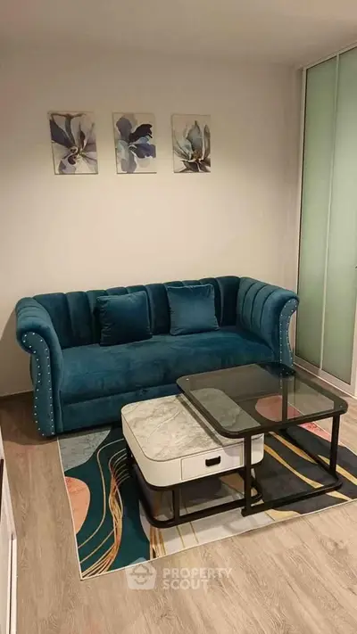 Stylish living room with teal velvet sofa and modern coffee table