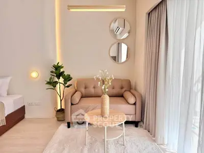 Chic modern living room with cozy sofa, stylish decor, and natural light from large windows.