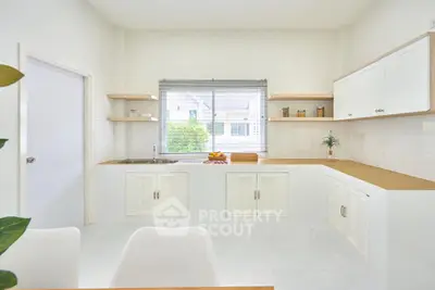 Bright modern kitchen with sleek white cabinets and natural light