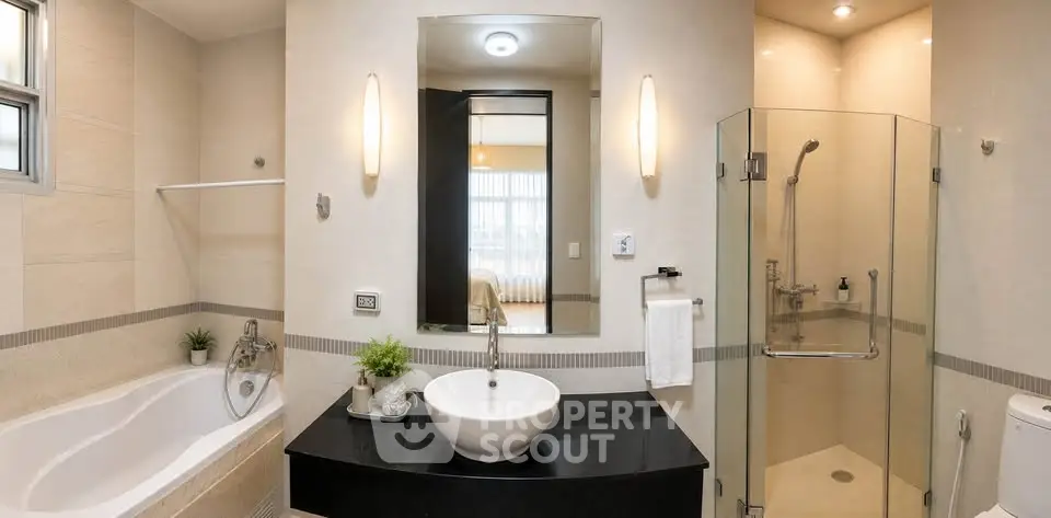 Luxurious modern bathroom with glass shower and elegant bathtub