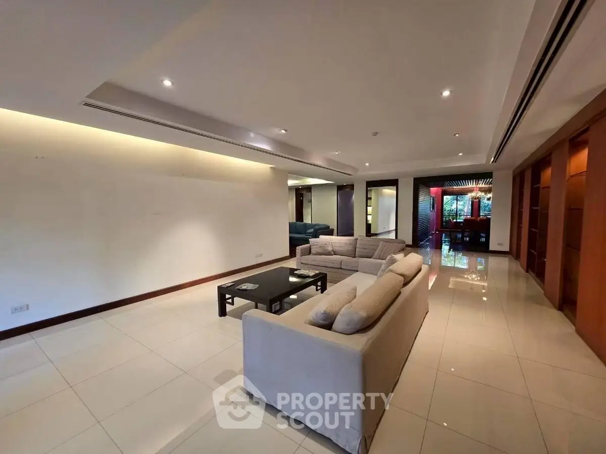 Spacious modern living room with elegant lighting and stylish furniture.