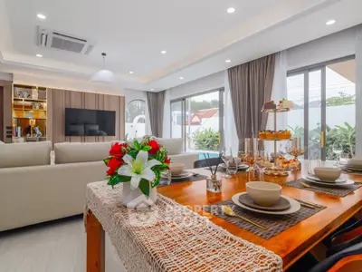 Luxurious open-plan living and dining area with elegant decor and ample natural light.