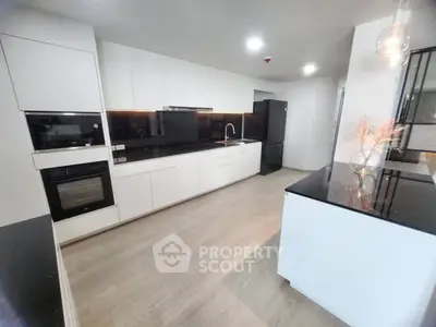 Modern kitchen with sleek black countertops and white cabinetry