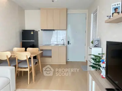 Modern living room with open kitchen, wooden furniture, and sleek appliances in a cozy apartment.
