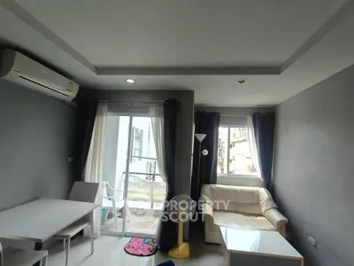 Modern living room with balcony access and air conditioning