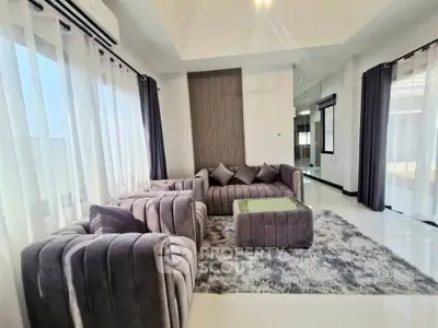 Luxurious modern living room with plush gray sofas and elegant decor